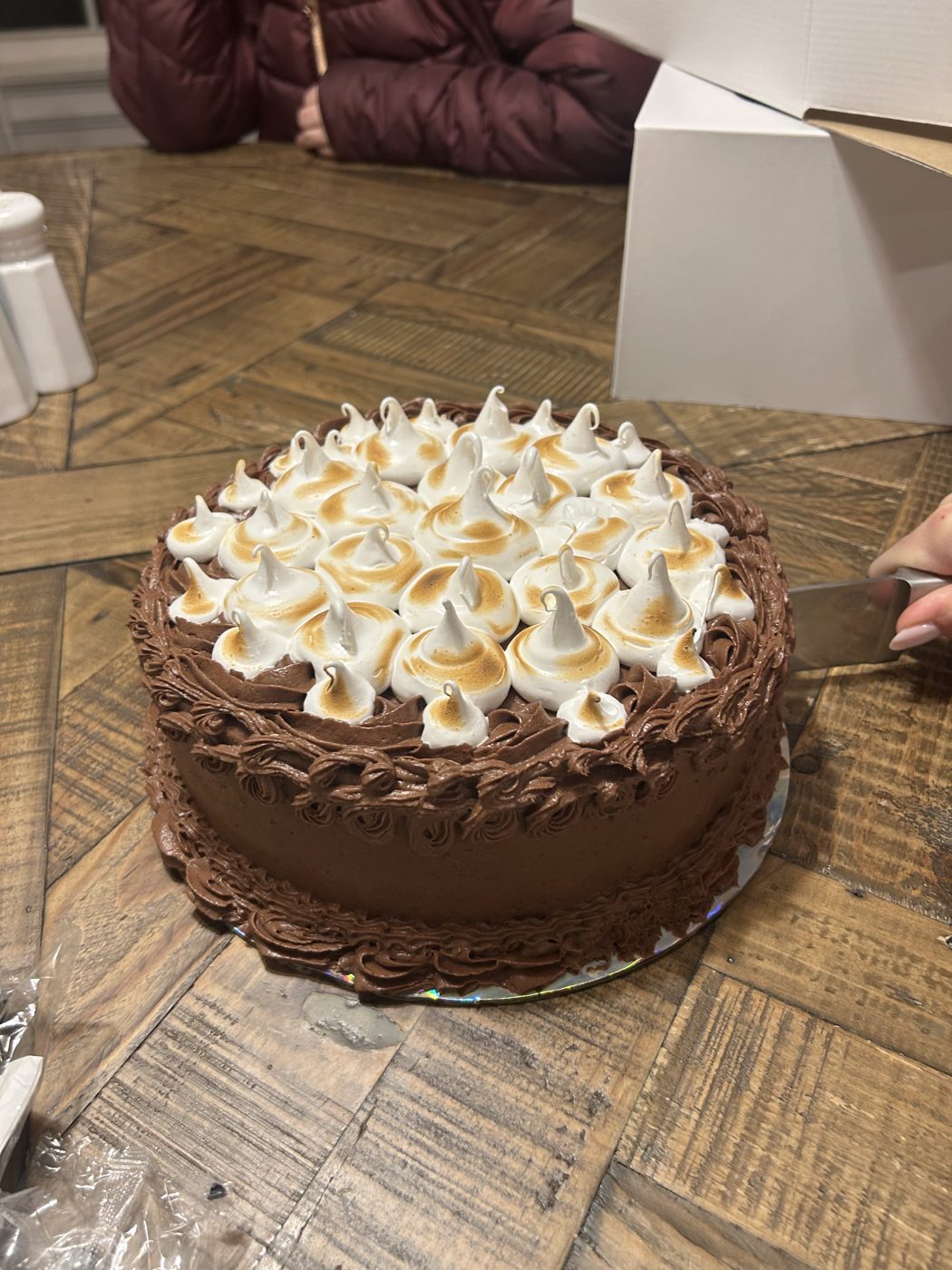 Chocolate cake topped with hand-torched meringue peaks